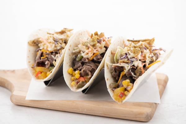 Steak Strip Tacos with Creamed Corn Elote and Jalapeño Ranch Slaw